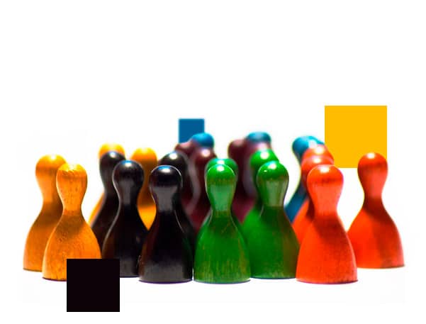 A symbolic photograph of a diverse crowd of colorful wooden game pieces (pawns) gathered together, representing a specialized talent pool for an EdTech Staff Augmentation project.