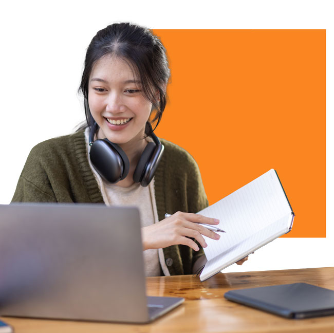 Young woman reading text books and watching her laptop