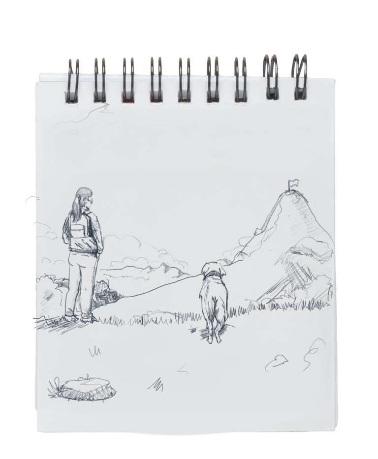 A white notebook where is a drawing of a girl staring the mountain top with her dog in the side