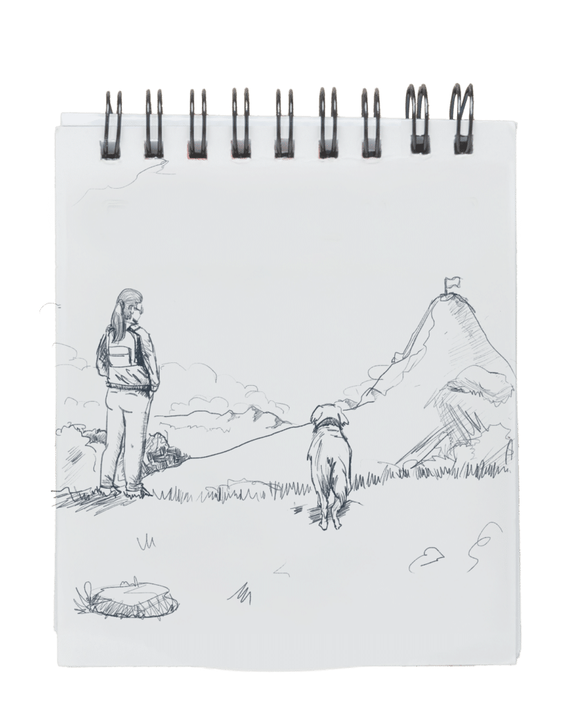 A white notebook where is a drawing of a girl staring the mountain top with her dog in the side